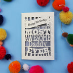 Daddy Birthday card for 'The Most Awesome Daddy Ever' on a blue background with colourful pom-poms.