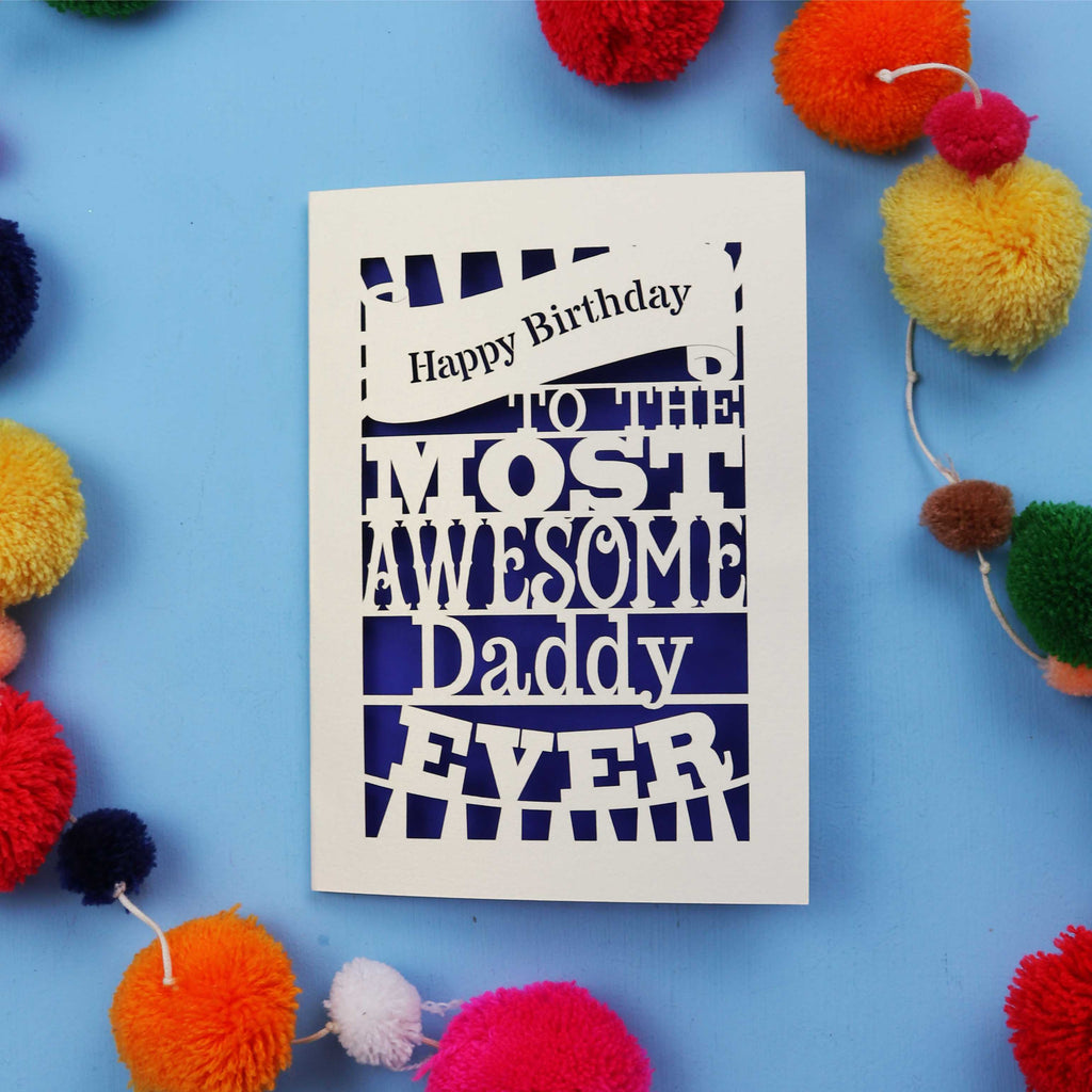 Daddy Birthday card with colourful text on a blue background with pom-poms