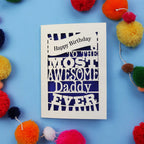 Daddy Birthday card with colourful text on a blue background with pom-poms