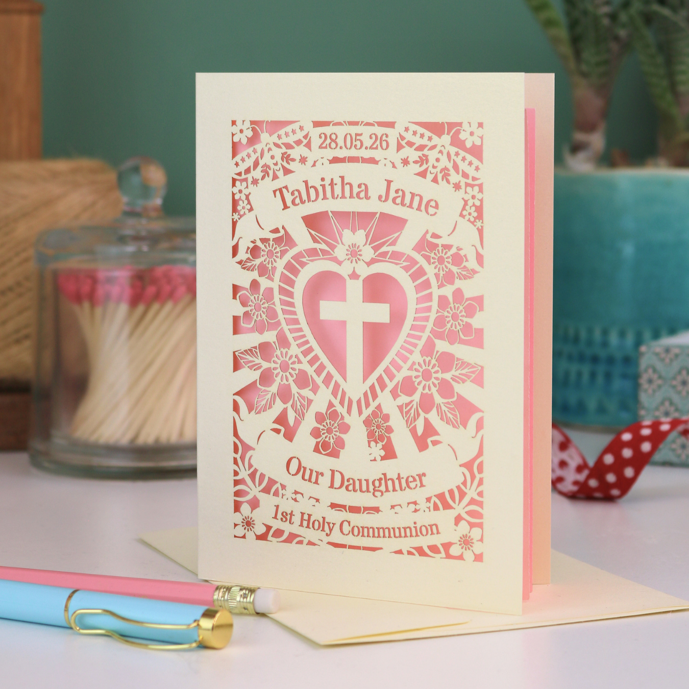 An intricate laser cut Daughter 1st Holy Communion card personalised with the date and name. 