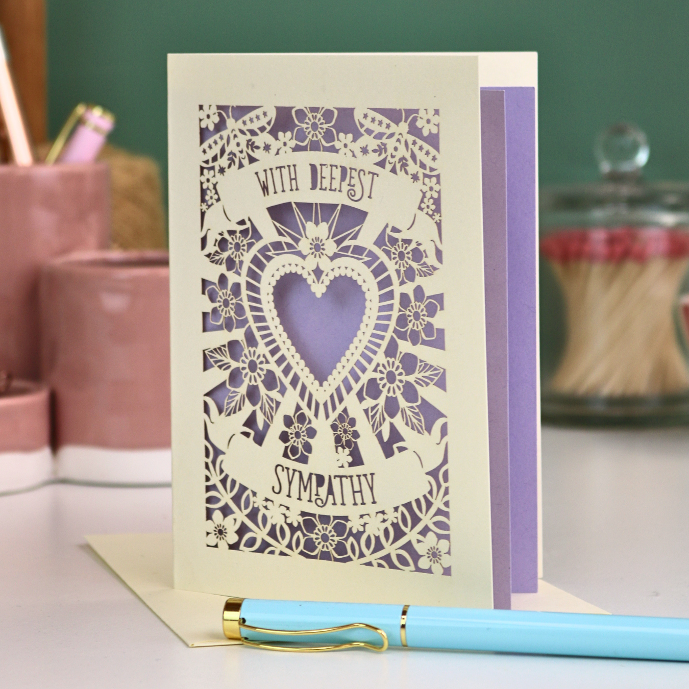 A cream and lilac laser cut sorry for your loss card with cut out heart and flowers design and the text 'With Deepest Sympathy'