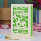 A laser cut first birthday card with cut out digger and "HAPPY BIRTHDAY TAYLOR" personalised text. 
