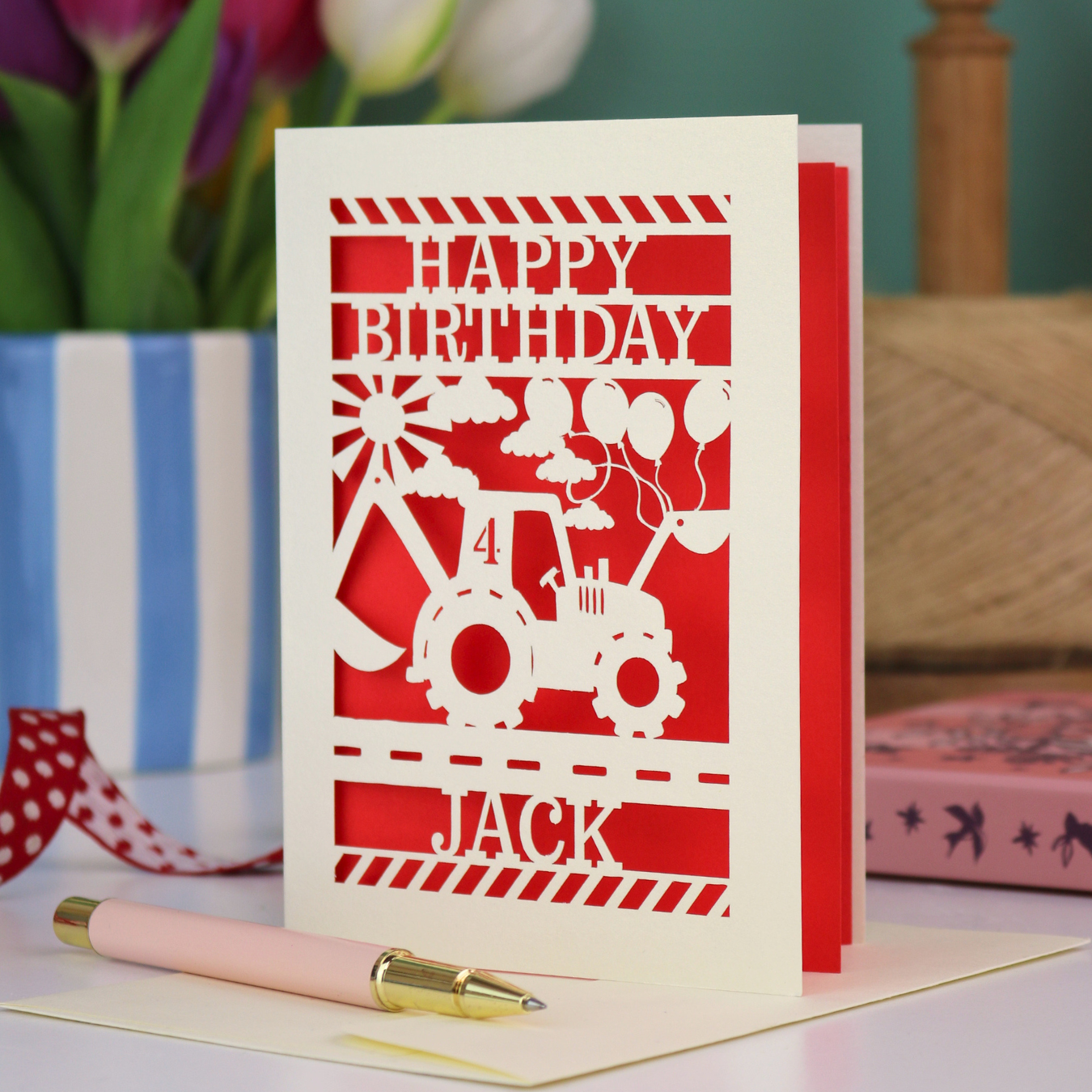 A son birthday card with laser cut digger design and "Happy Birthday" text, personalised with a name and age. 