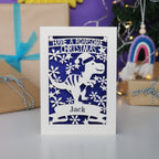 Laser cut Christmas card with dinosaur design