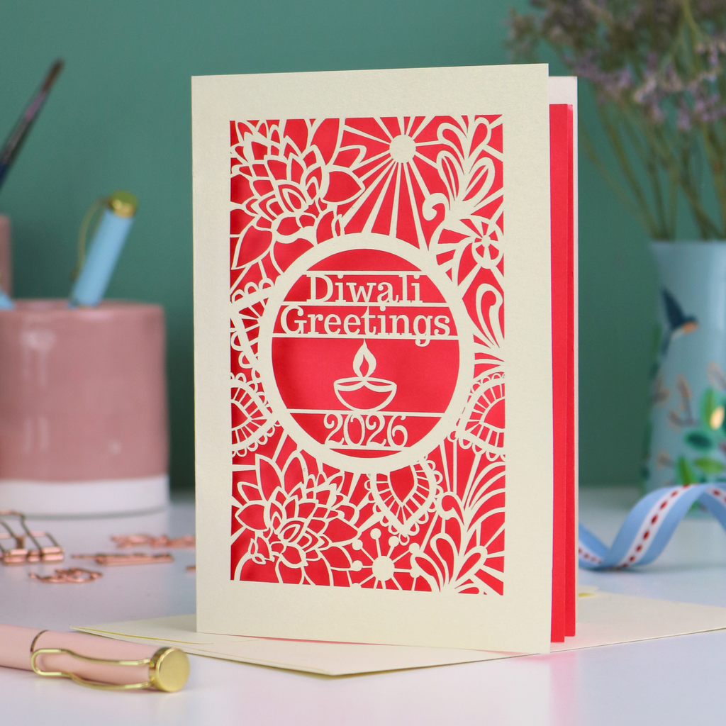 Diwali greeting card with intricate design and 'Diwali Greetings 2026' text on a desk.