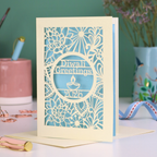 Laser Cut Diwali greetings card with intricate design and 'Diwali Greetings 2026' text on a desk.
