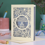 Laser Cut Diwali greetings card with intricate design and 'Diwali Greetings 2026' text on a desk.
