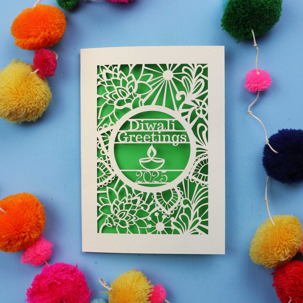 Laser Cut Diwali card with decorative elements on a blue background