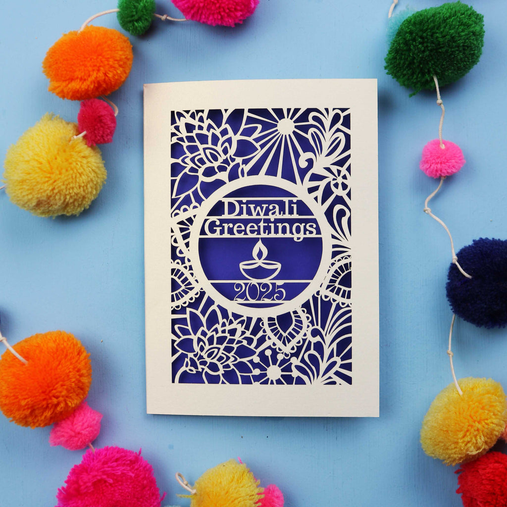 Laser Cut Diwali card with decorative elements on a blue background