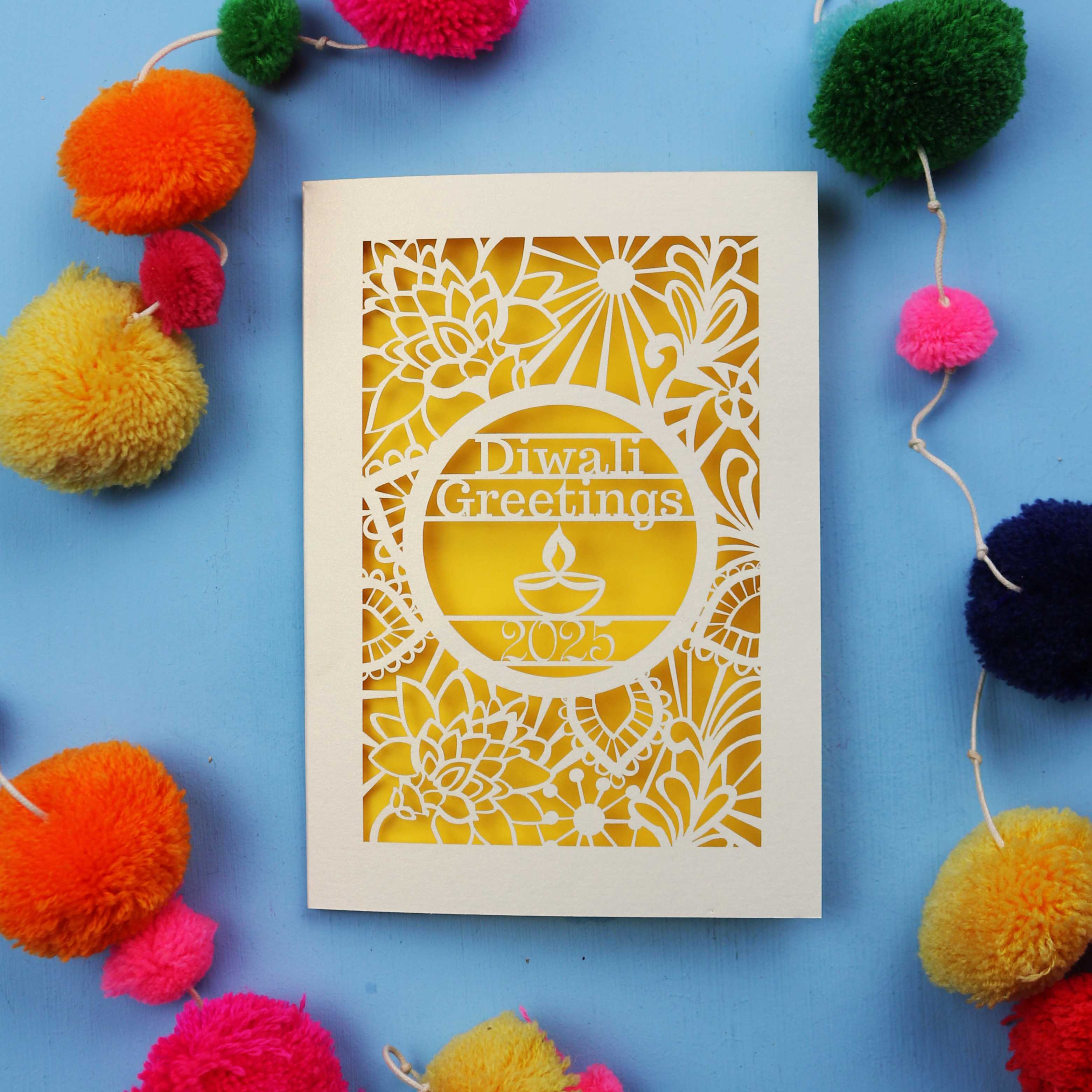 Laser Cut Diwali card with decorative elements on a blue background
