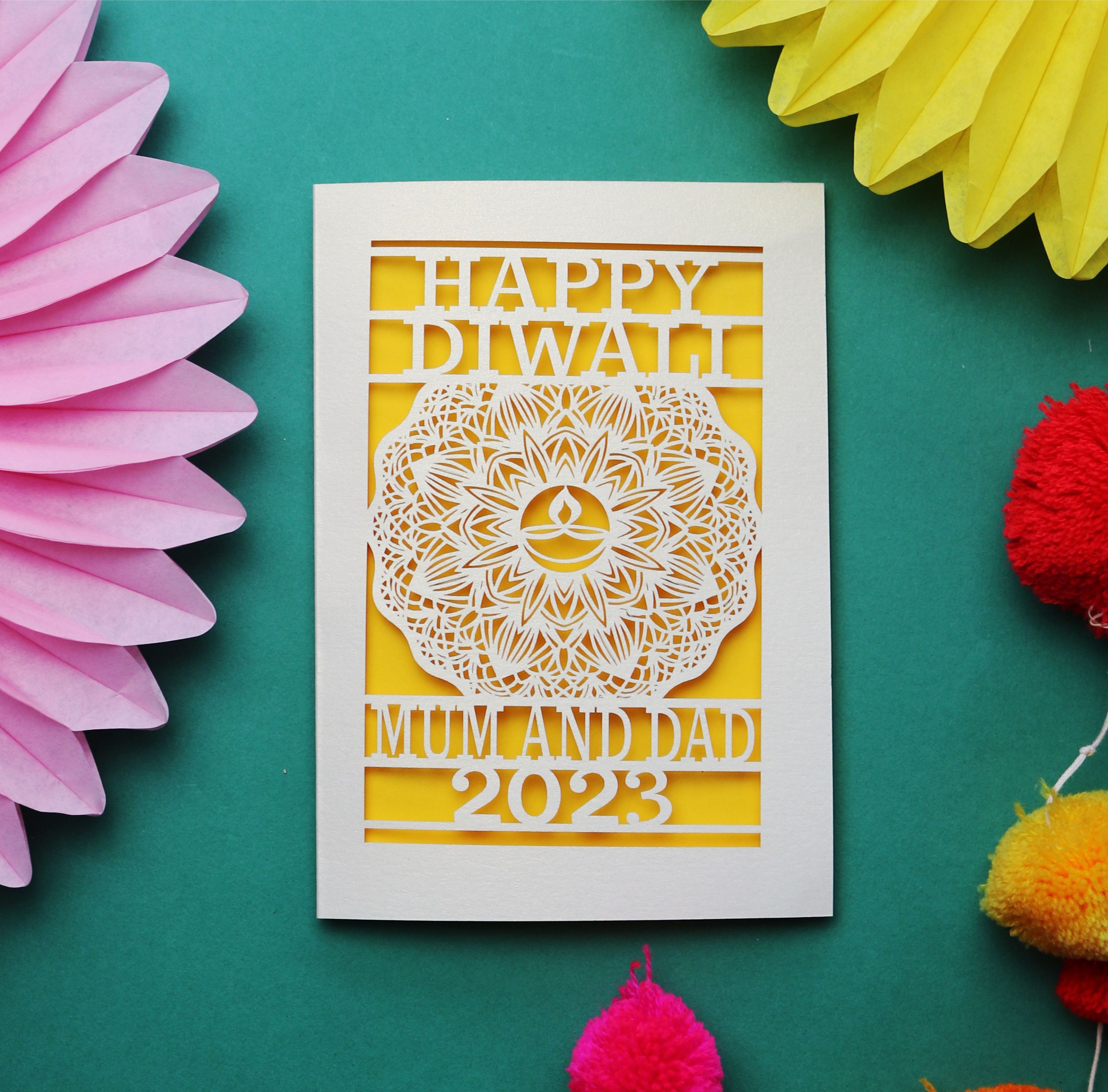 A laser cut card for Diwali, personalised with recipients' names and the year
