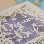 Decorative paper cutout with 'Dream Big' text on a lilac background