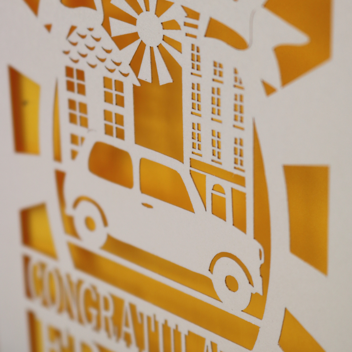Paper cut out art of a car and buildings 