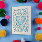 Decorative engagement card with 'Congratulations Mr & Mrs' text on a blue background with colourful pom-poms.