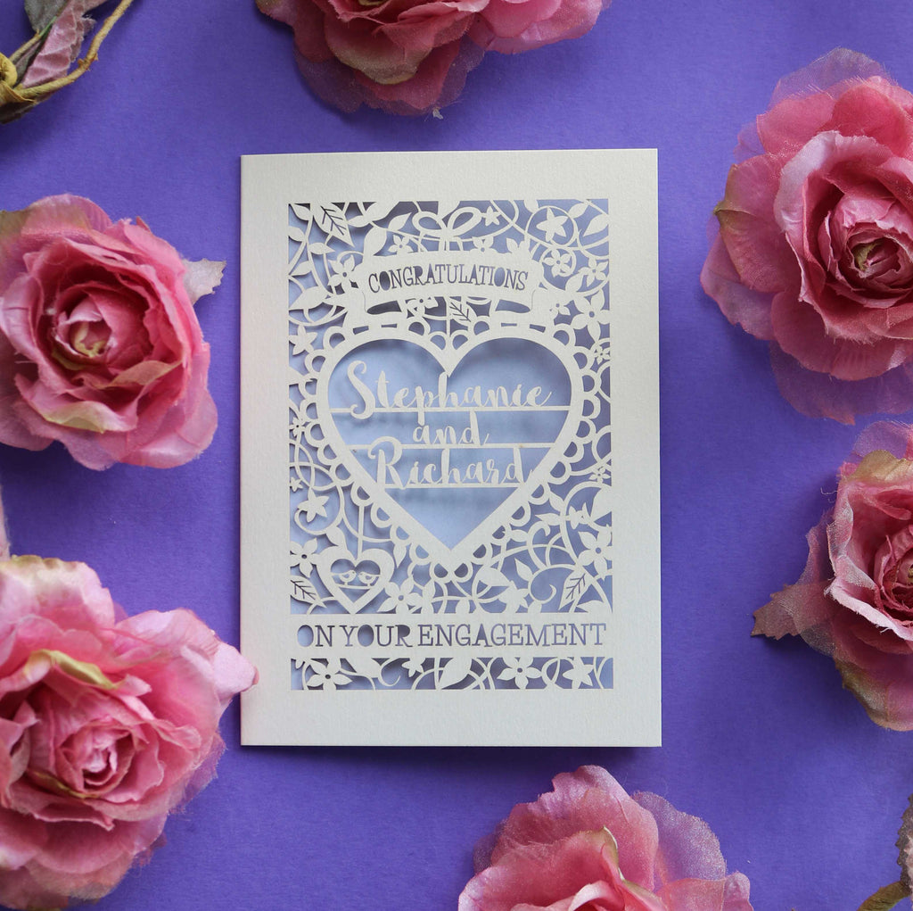An engagement card with "Congratulations on your engagement" with two names in a heart