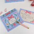 Decorative notecard with swan design, pen, and gift box on a white background