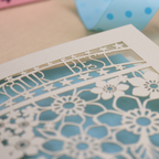 Decorative laser cut greetings card with floral design and text, 'Your best is plenty' on a table with stationery items.