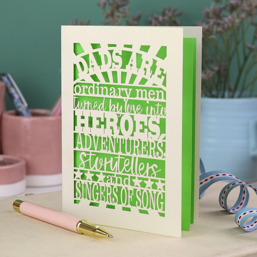 A laser cut father's Day card with cut out quote, "Dads are ordinary men turned by love into heroes, adventurers, storytellers and singers of song", with a cream card and bright green paper insert