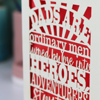A laser cut father's Day card with cut out quote, "Dads are ordinary men turned by love into heroes, adventurers, storytellers and singers of song", with a cream card and bright red paper insert