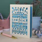 A laser cut father's Day card with cut out quote, "Dads are ordinary men turned by love into heroes, adventurers, storytellers and singers of song", with a cream card and bright blue paper insert