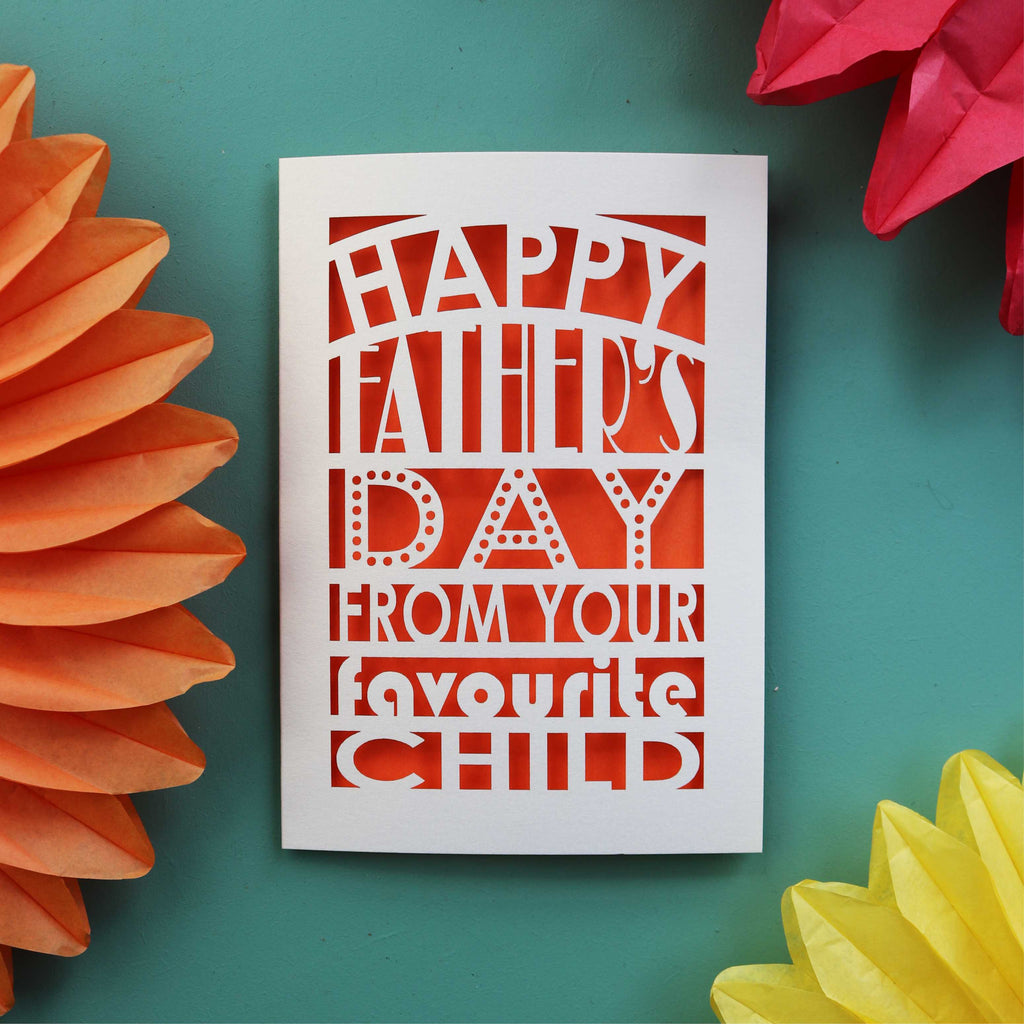 A unique fathers day card laser cut from cream card with an orange paper insert. Card reads "Happy Father's Day from your favourite child"