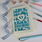 New Baby Card with decorative elements on a white surface with stationery items.