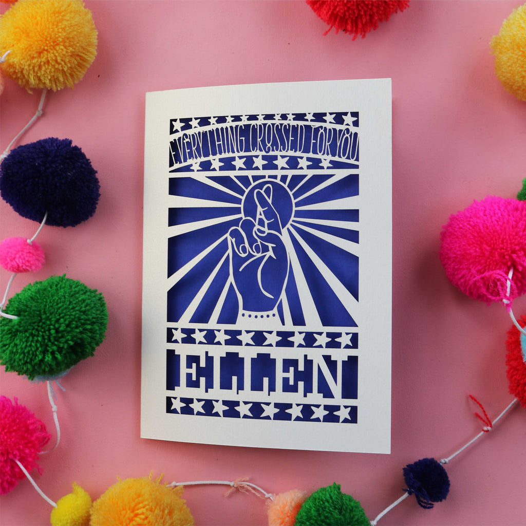 A cut out good luck in your exams card with fingers crossed