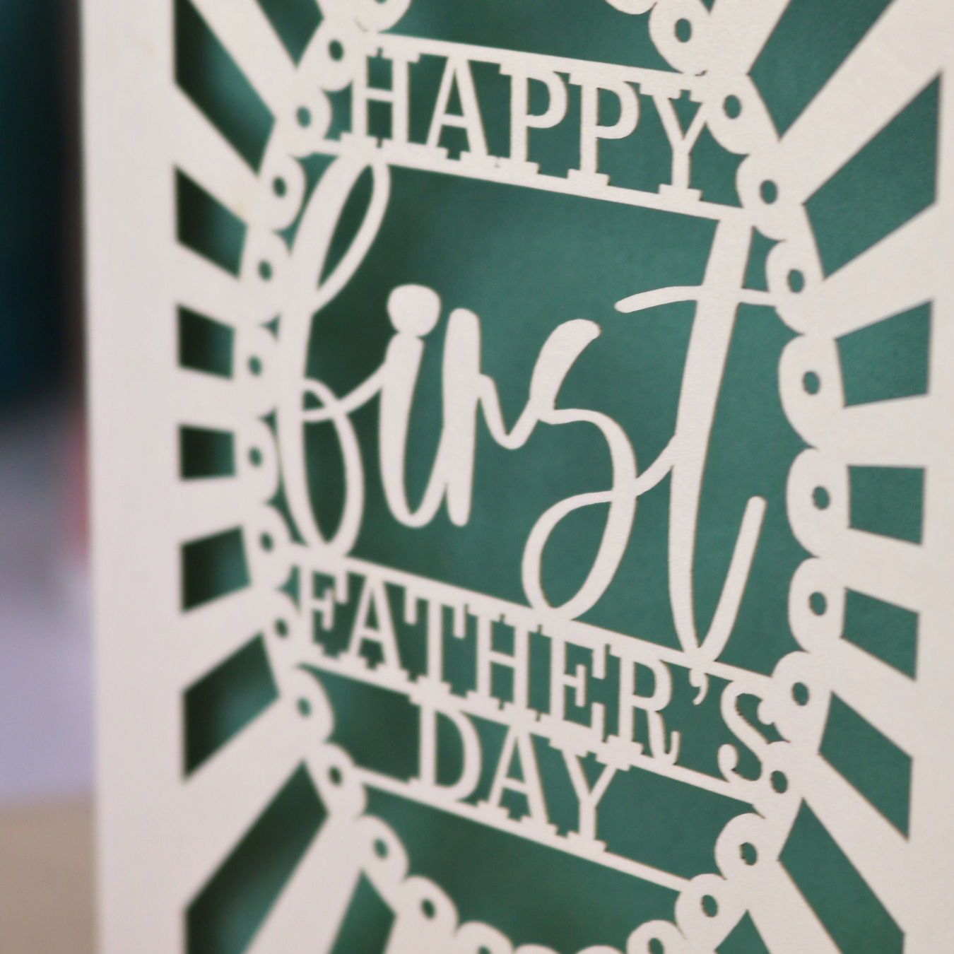A laser cut first Father's Day card with "Happy first Father's Day" text in a sunbeam design