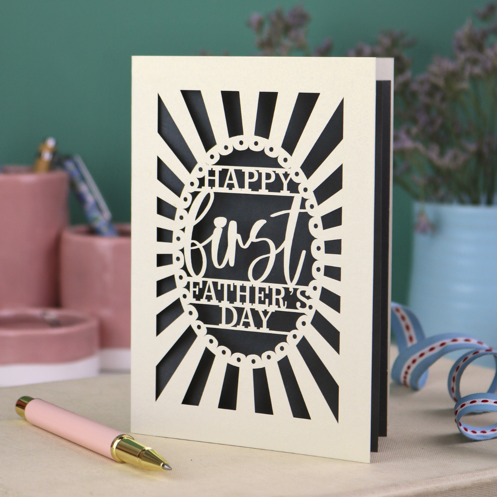 A laser cut first Father's Day card with "Happy first Father's Day" text in a sunbeam design