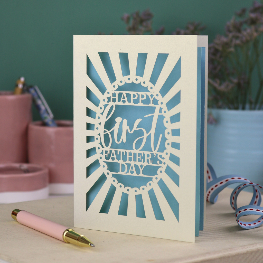 A laser cut first Father's Day card with "Happy first Father's Day" text in a sunbeam design