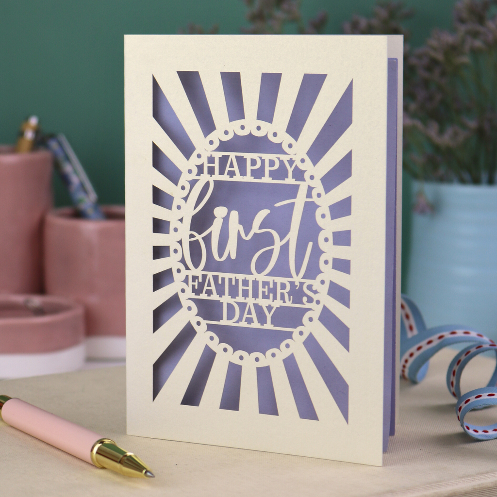 A laser cut first Father's Day card with "Happy first Father's Day" text in a sunbeam design