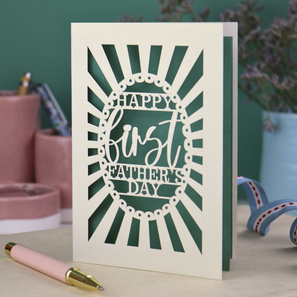 A laser cut first Father's Day card with "Happy first Father's Day" text in a sunbeam design