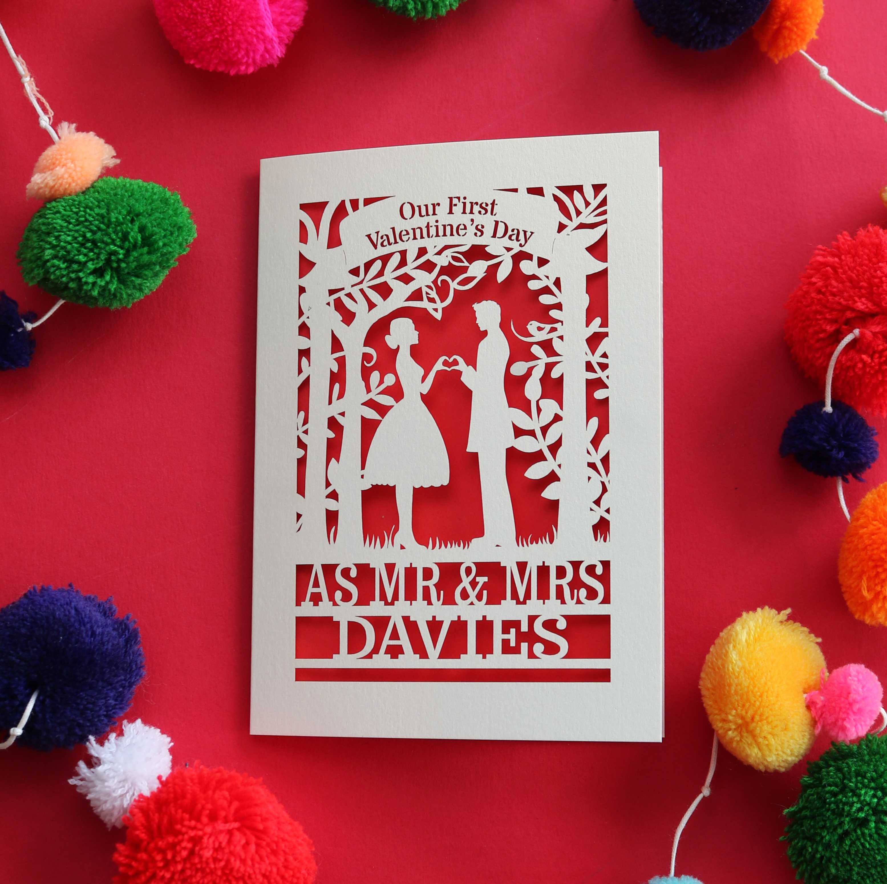 Personalised first Valentine's Card featuring laser cut couple making a heart with their hands, and the words "Our First Valentines Day as Mr & Mrs Davies"