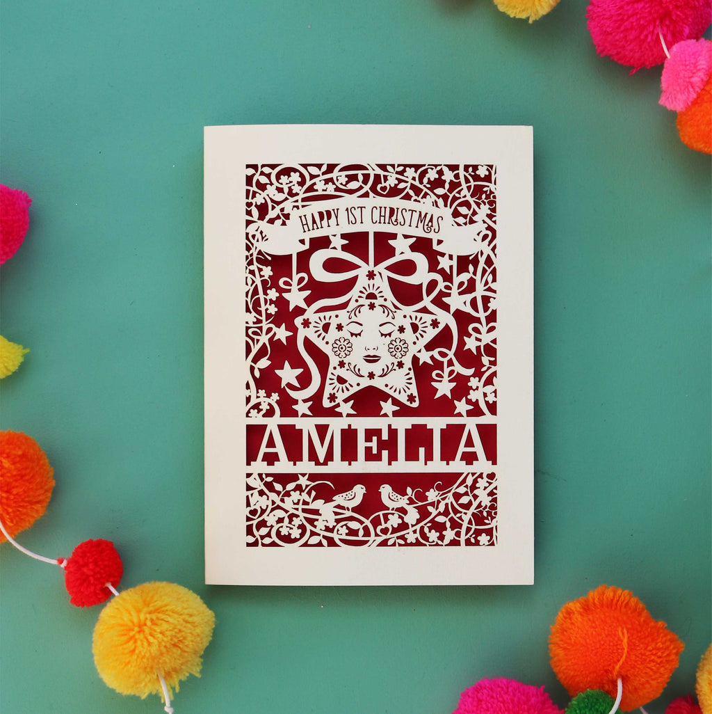 A first Christmas card with baby's name and a star. Cut out cards are cream, this one has a dark red paper behind it.