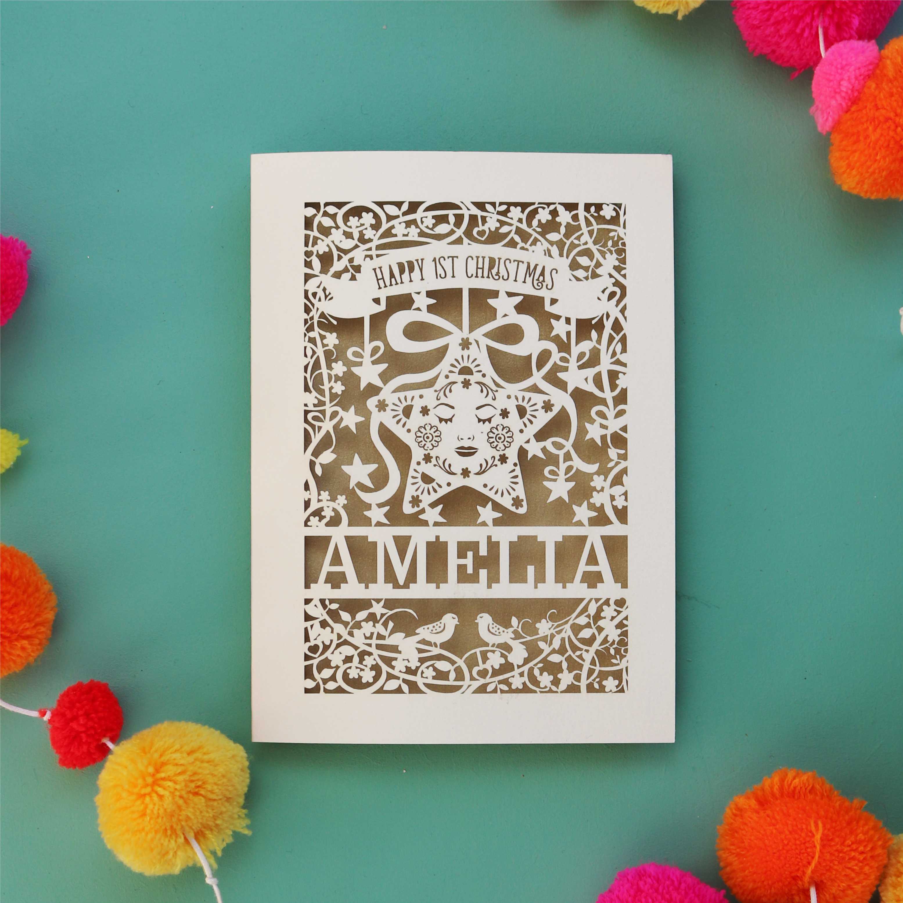 A cream and gold leaf laser cut Christmas card for babies. 