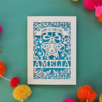 A paper cut 1st Christmas card in cream with a blue paper insert. Card is personalised with a name