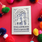 A personalised Valentines Card featuring cut out silhouettes of a couple, personalised with their names. Card says "Our First Valentine's Day" at the top.