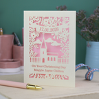 A laser cut floral Christening card with cut out church design and the date in a stencil font in a banner, with "On Your Christening Day" and the name "Maggie Jayne Chilton" underneath.