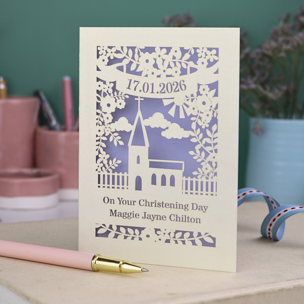 A laser cut floral Christening card with cut out church design and the date in a stencil font in a banner, with "On Your Christening Day" and the name "Maggie Jayne Chilton" underneath.
