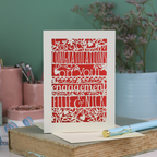 Engagement card with personalized text on a book with stationery items in the background