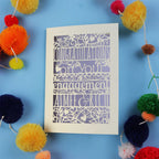 Unique luxury laser cut engagement Card with 'Congratulations on your engagement' text on a blue background with colourful pom-poms.