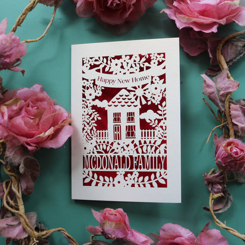 A personalised house warming card with a house, flowers and the words "Happy new home" - A6 / Dark Red