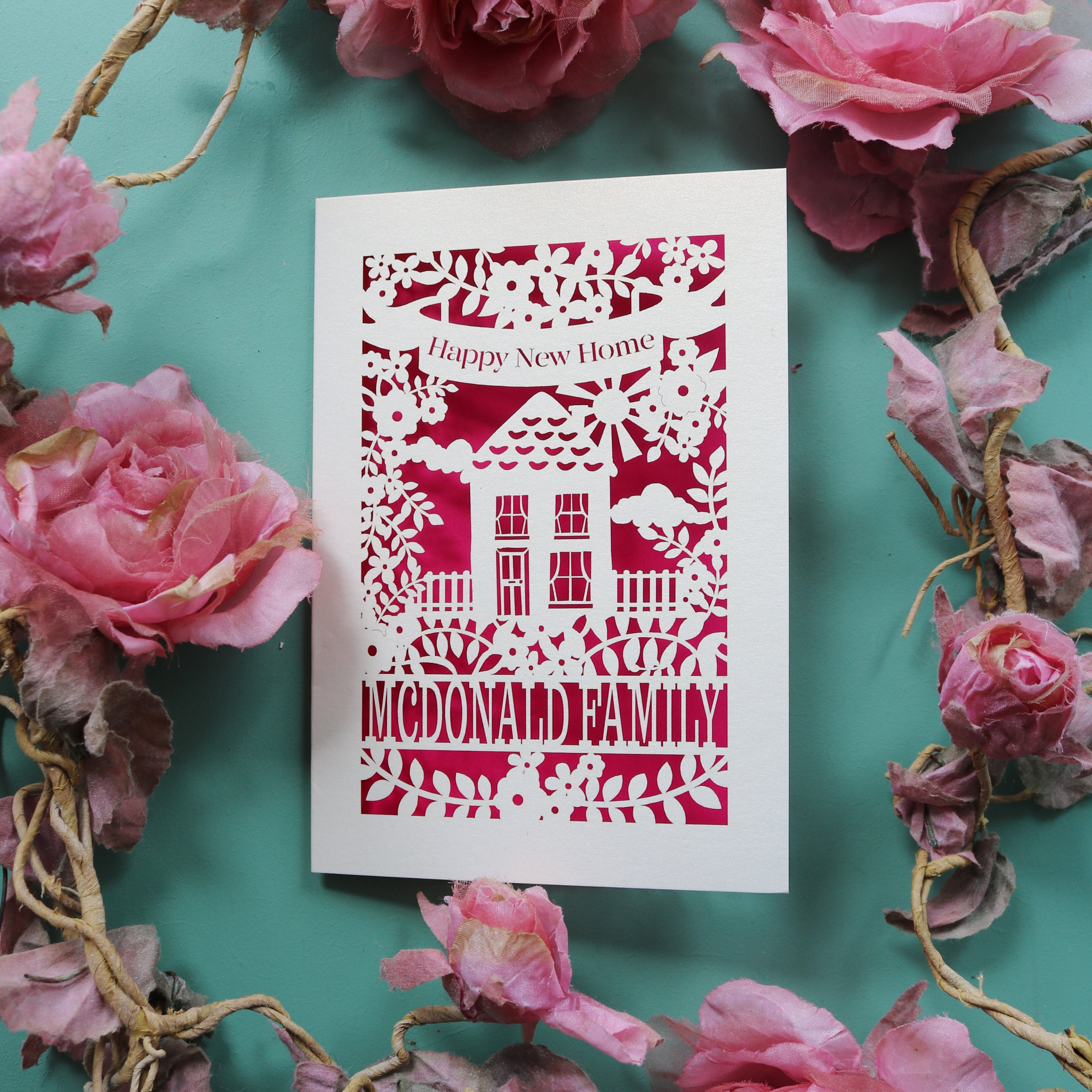 Cute paper cut new home cards. Card says "Happy new home" and is personalised with the recipient/s' name in a line of text