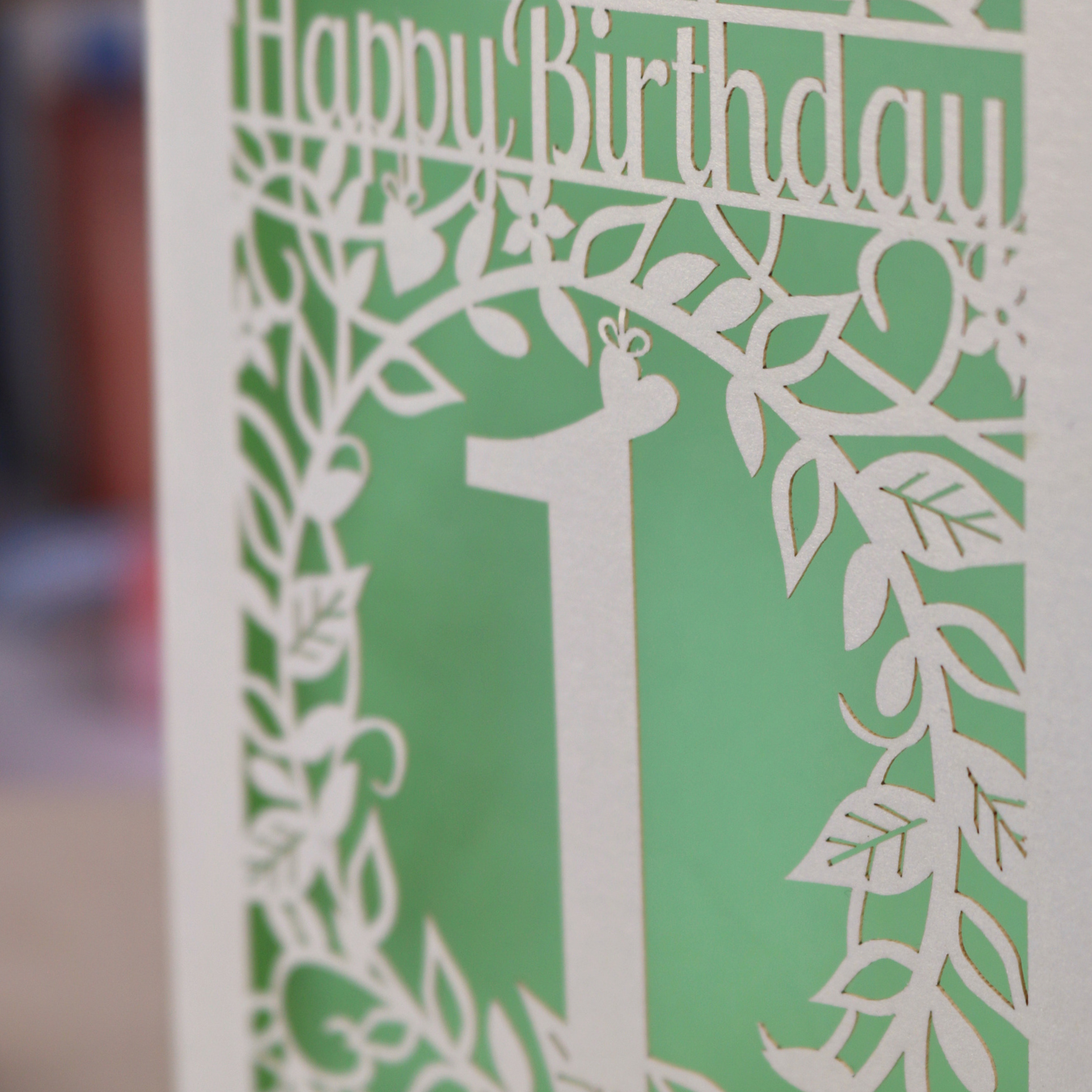 Laser cut 1st Birthday card with cut-out floral design and "Happy Birthday"