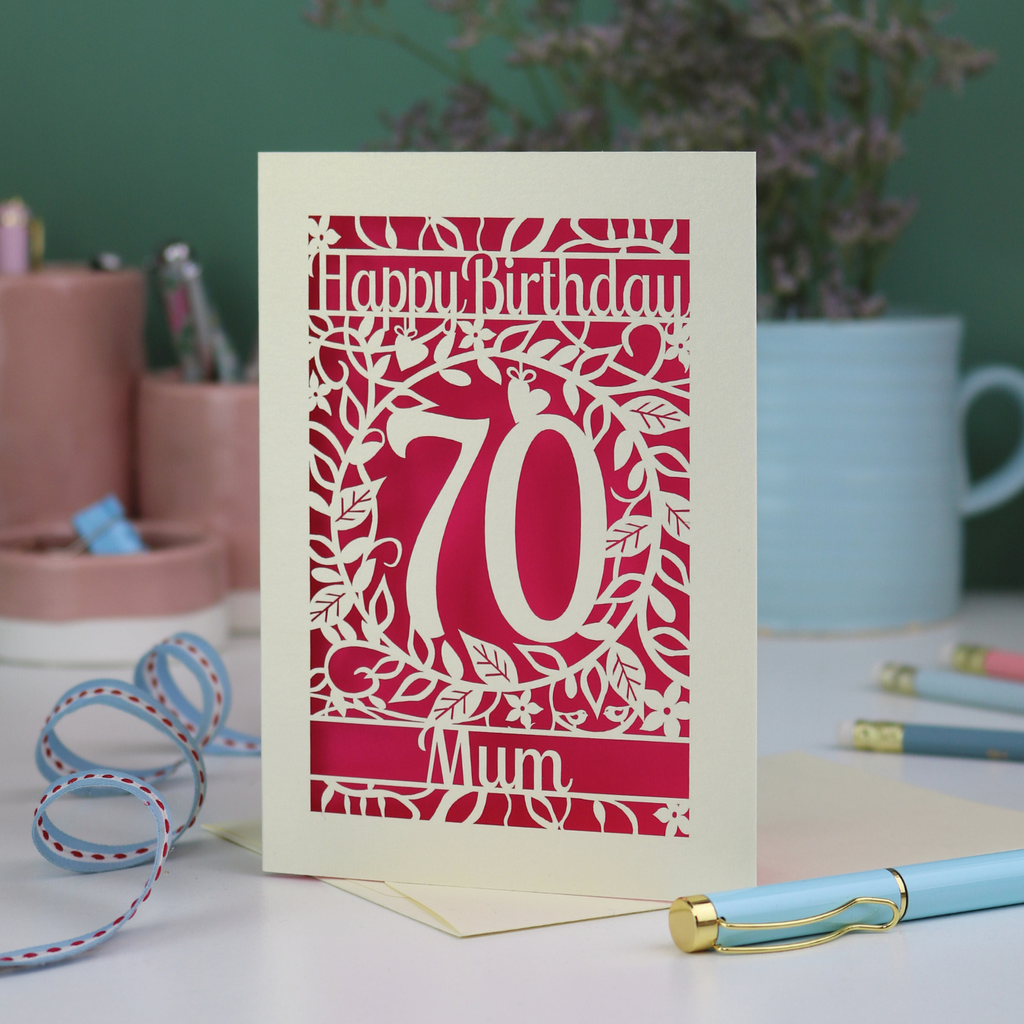 A 70th birthday card, laser cut with floral design and 'Happy Birthday', with a name at the bottom and a big number 70 in the centre. 