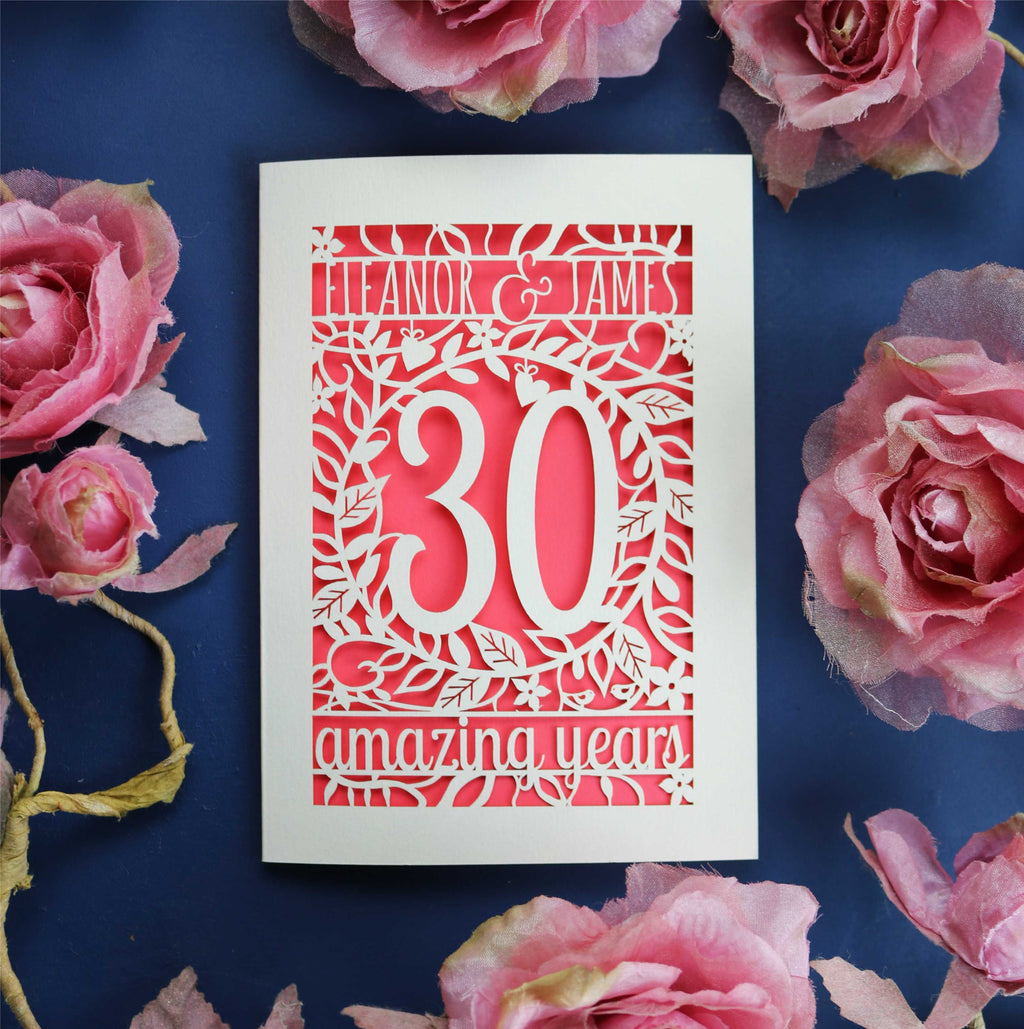 A cream and coral anniversary card. Card is laser cut and features floral details and text.