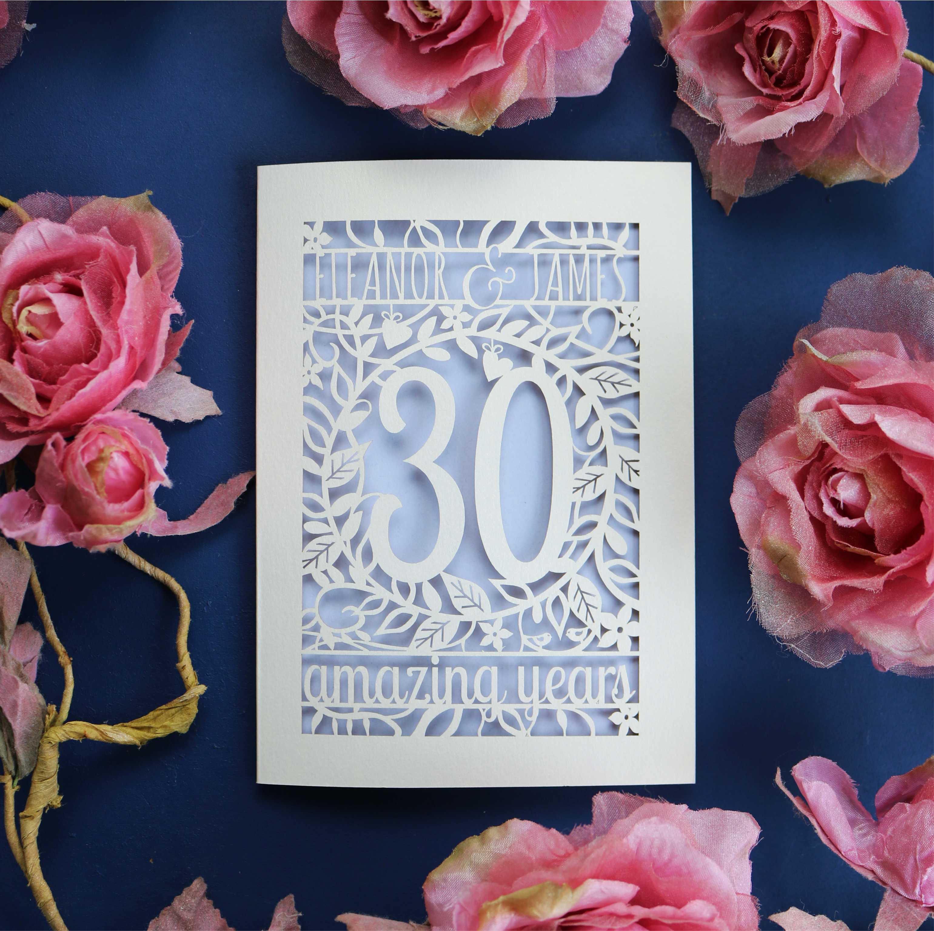 A cream and lilac anniversary card, laser cut with personalisation and floral details. 
