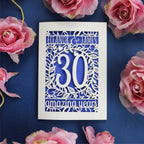 A cream and violet laser cut card for a 30th anniversary. Card is personalised with text and has intricate floral details in the border. 