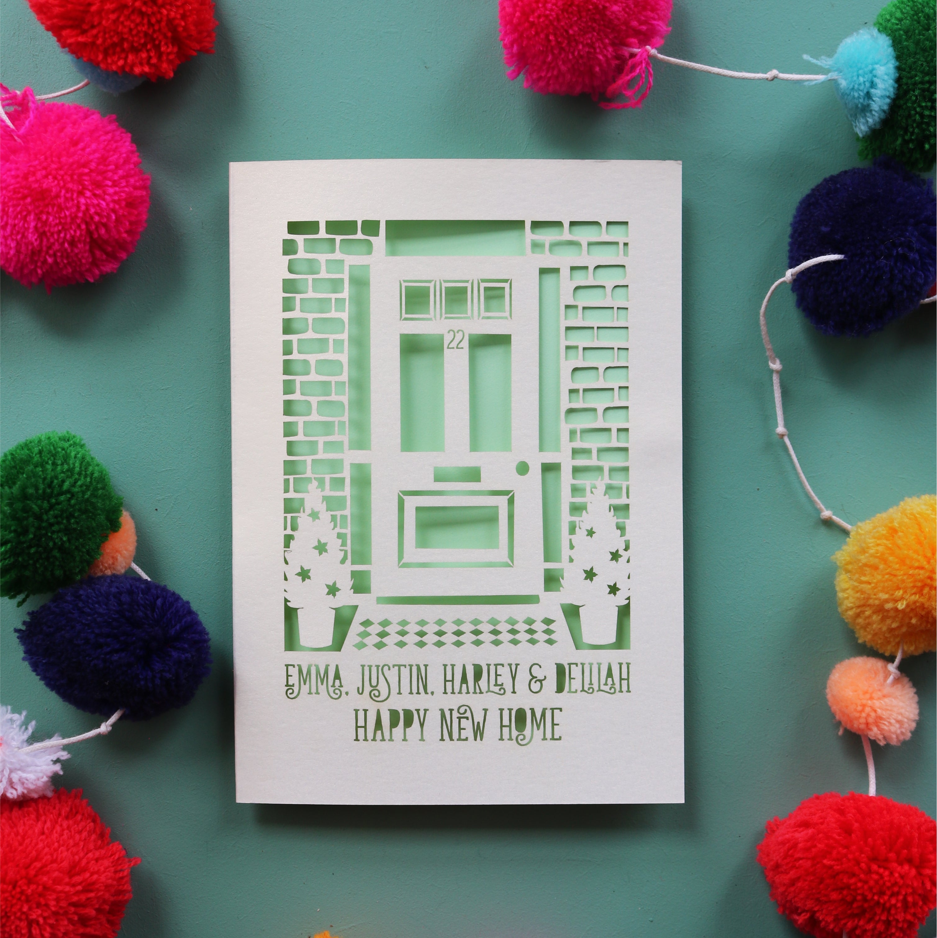 A unique housewarming card with laser cut front door and personalised text