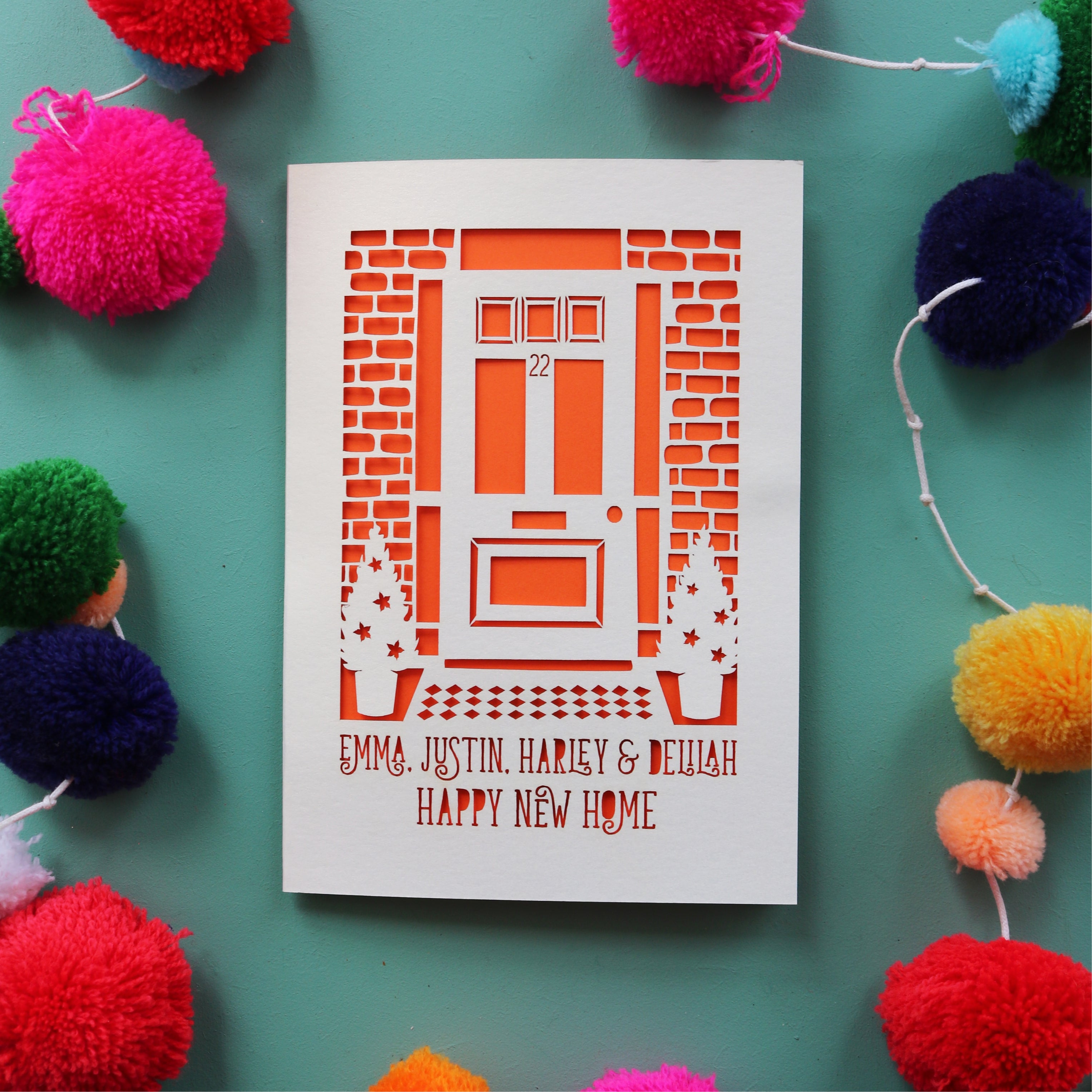 A paper cut new home card with personalised text over two lines